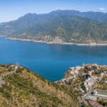 Aerial panoramic view of Tehri Lake, New Tehri city, blue reservoir water and Himalayan mountains in Uttarakhand.